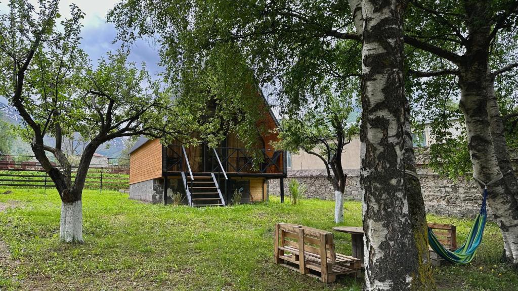a cabin in the middle of a field with trees at Kamara in Sioni