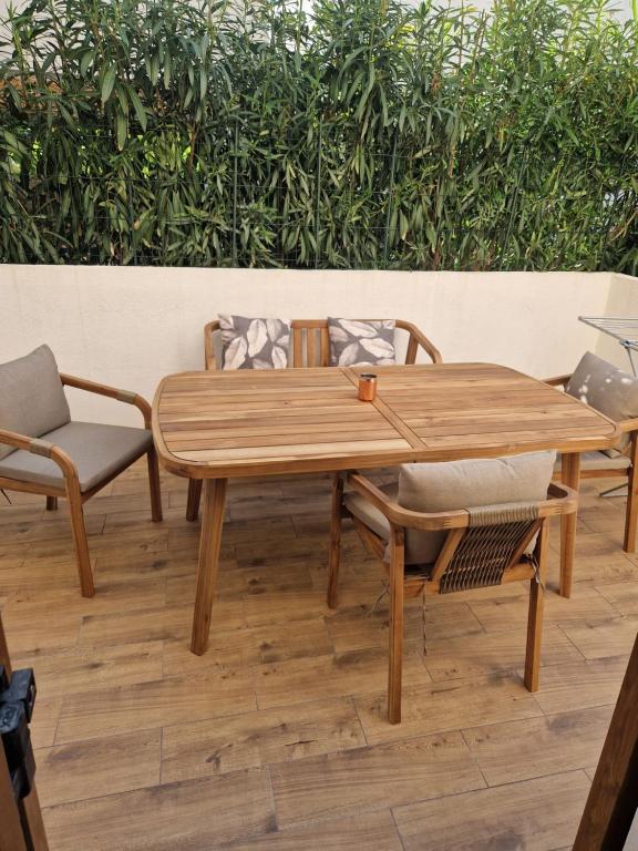 a wooden table and chairs on a patio at Vacation home Dora in Baška