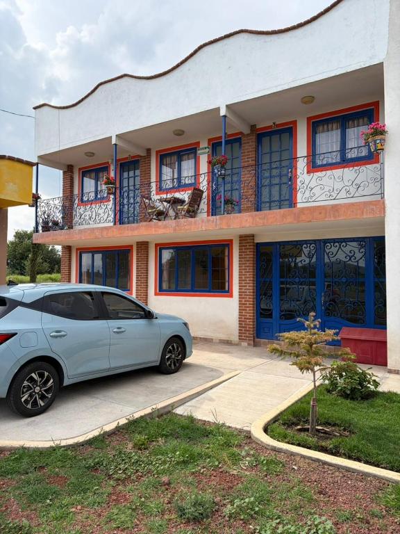 a car parked in front of a building at Hotel Casa Don Marcos in Ixtafiayuca