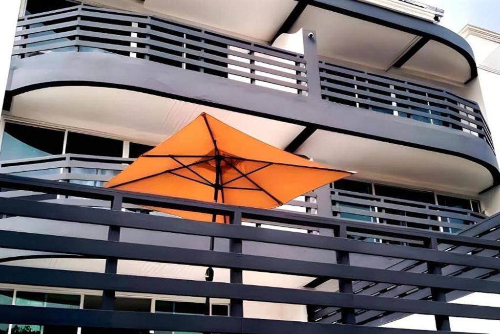 an orange umbrella hanging from the side of a building at VS Beach Front in Jomtien Beach