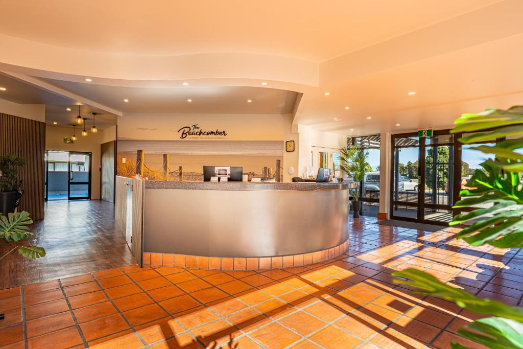 a lobby of a hotel with a bar at The Beachcomber Hotel in Nelson