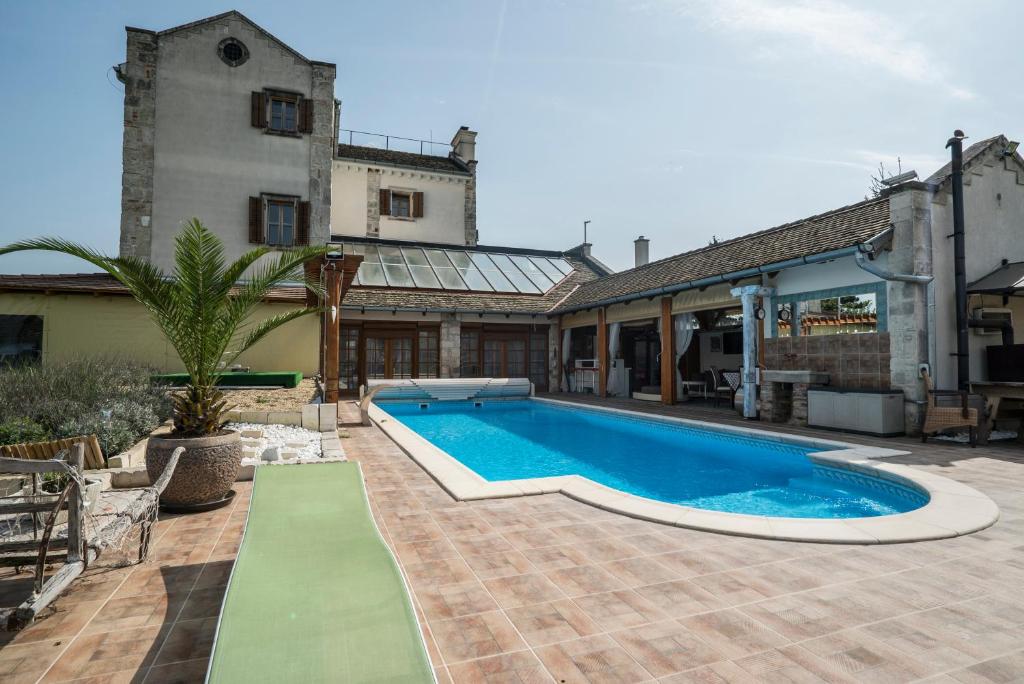 a swimming pool in the yard of a house at Villa Malom Luxury Resort in Pusztazámor