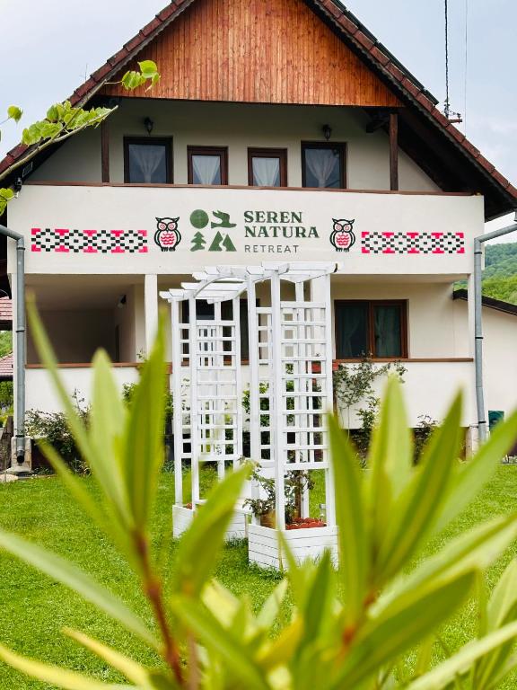 a building with a sign in front of it at Seren Natura Retreat in Sebeşu de Sus