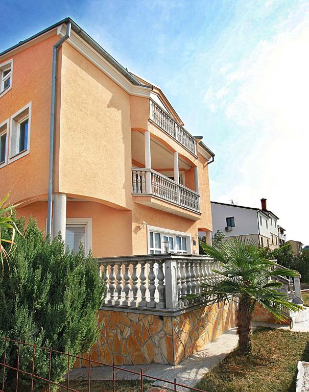 a building with a balcony on the side of it at Apartment Vukadin in Pula