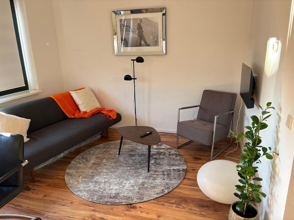 a living room with a couch and a chair at O21 Apartment in Amersfoort