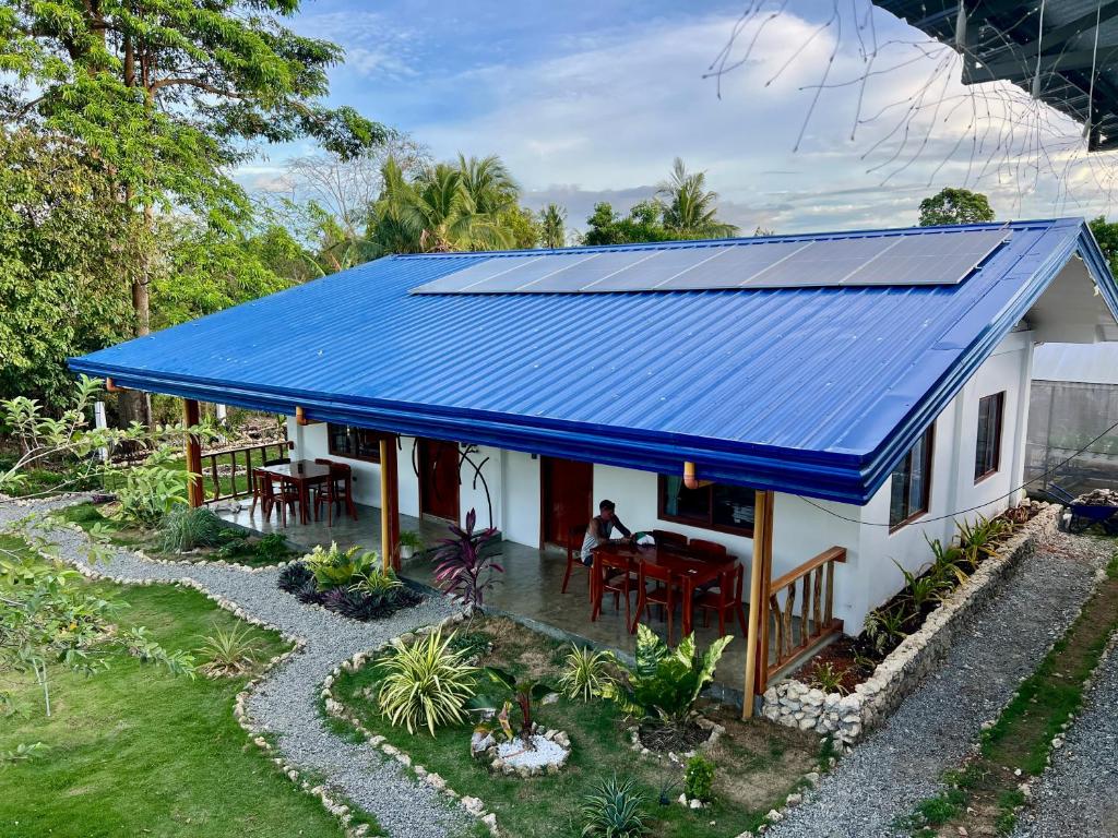 a house with a blue roof at Farm Village in San Juan