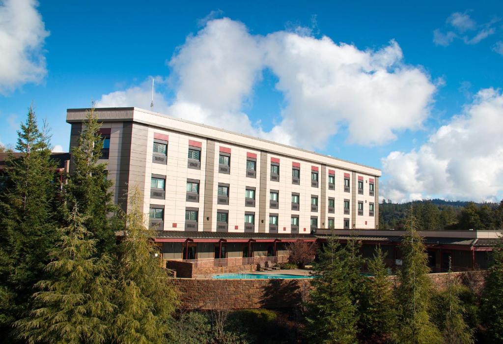 a large white building with trees in front of it at Jackson Rancheria Casino Resort in Jackson