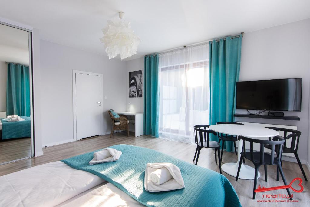 Televízia a/alebo spoločenská miestnosť v ubytovaní Apartments Nearto Old Town Rakowicka