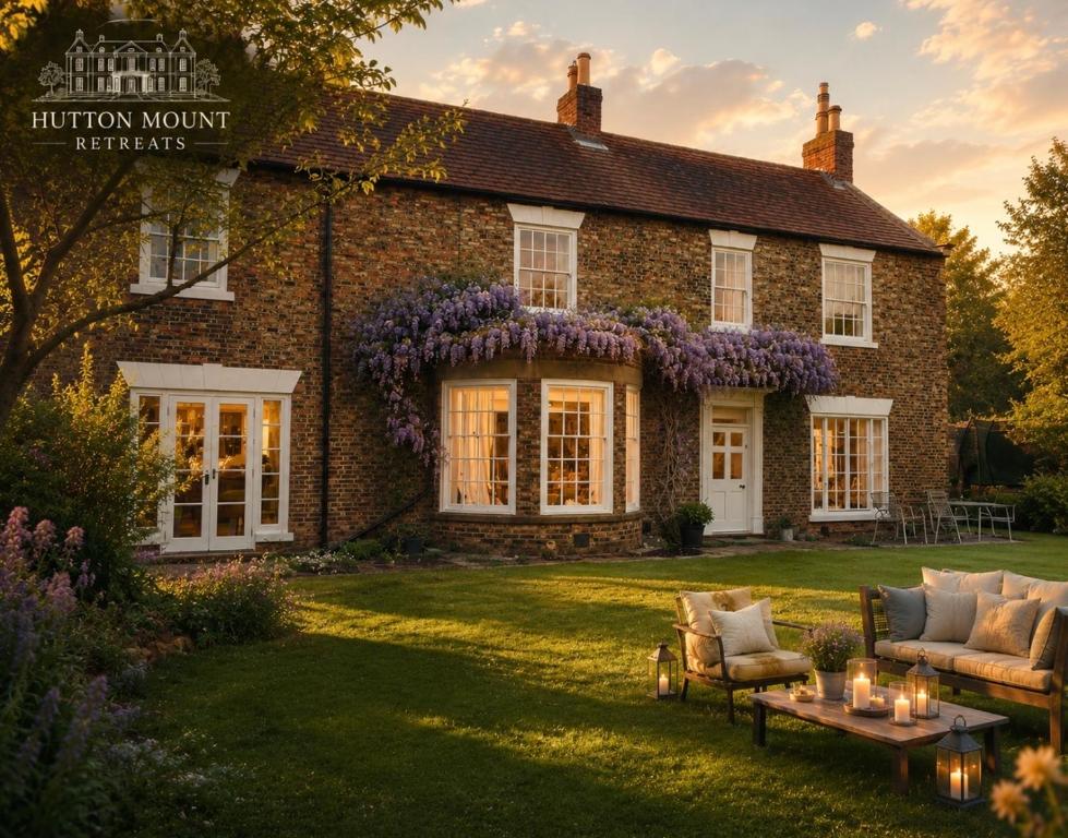 a brick house with a garden in front of it at Hutton Mount Retreats in Ripon