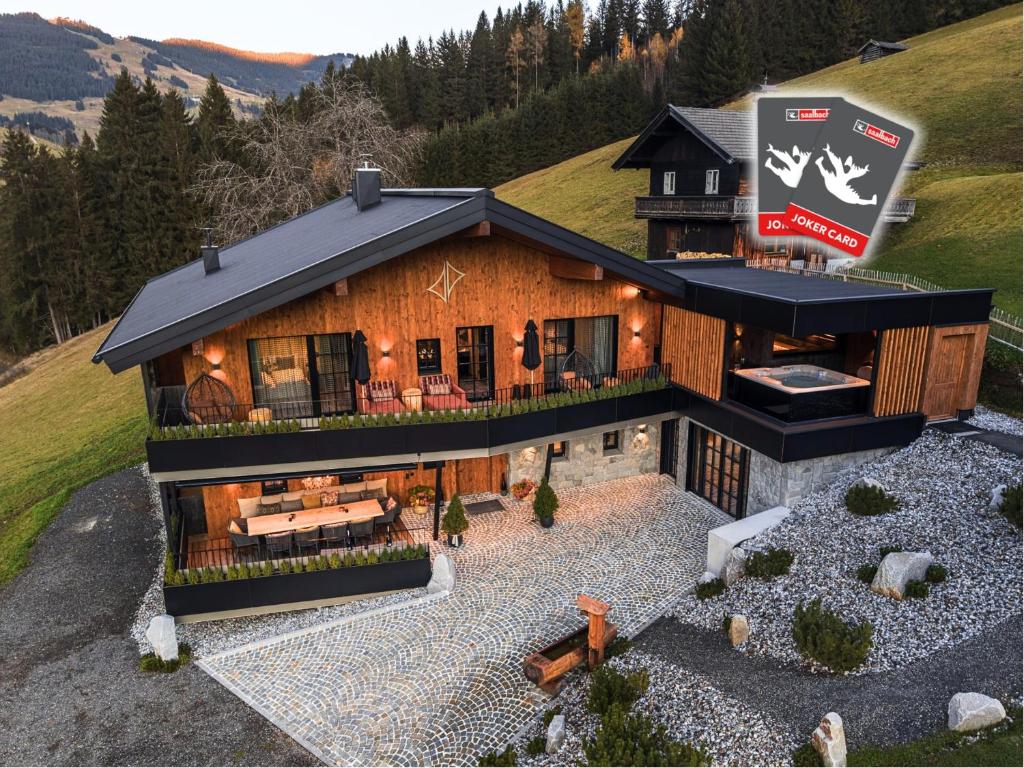 an aerial view of a house with a mountain at NANI - Mountain Chalet in Saalbach-Hinterglemm