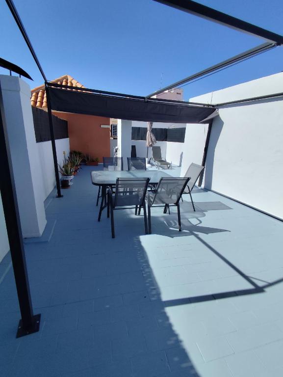 a patio with a table and chairs on a roof at Paraiso La Mata in La Mata
