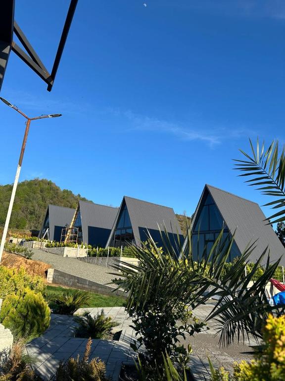 a row of buildings with a blue sky in the background at Flora-A in Chakvi