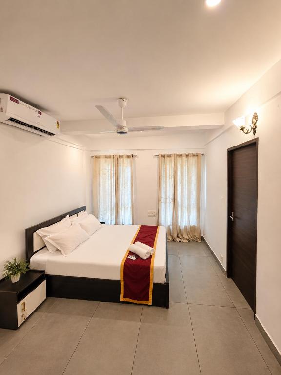 a bedroom with a large bed in a room at Zenora Suites in Kozhikode