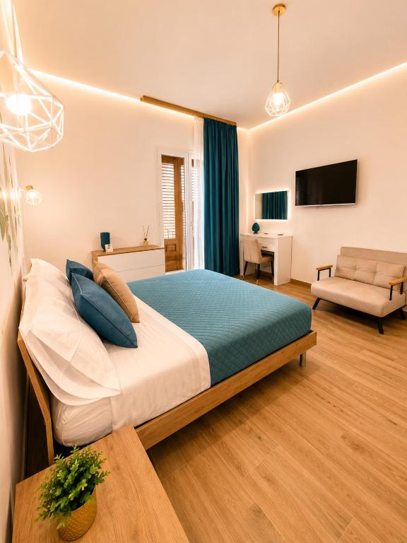 a bedroom with a bed and a living room at Sicily Luxury Apartments in Palermo