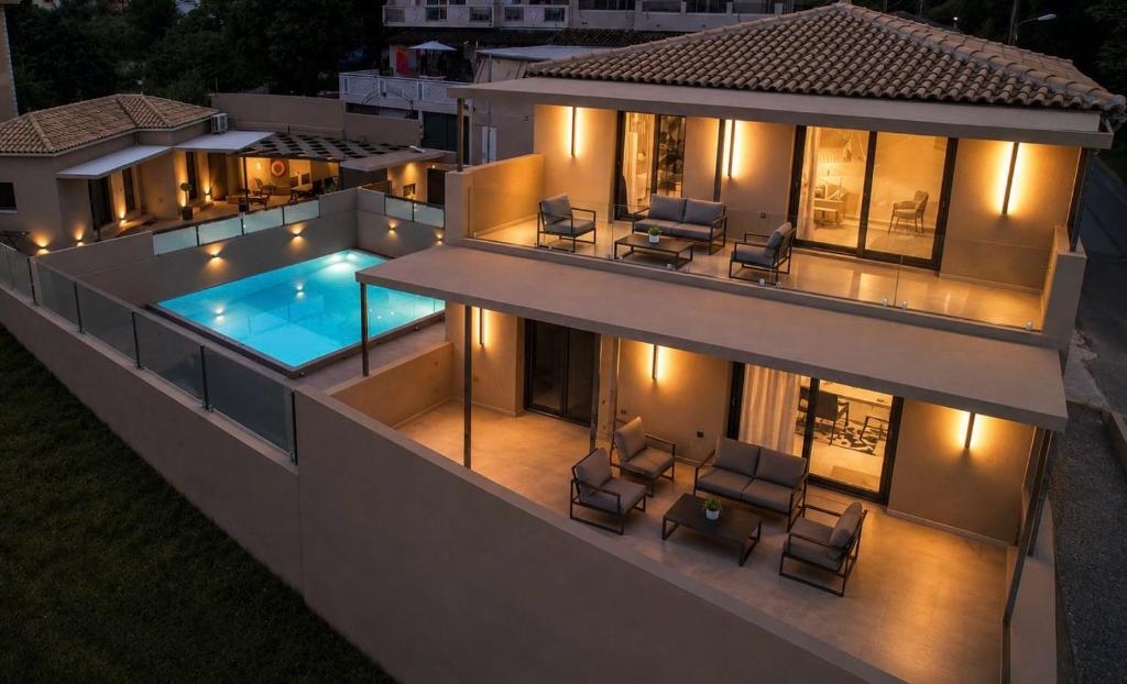 an aerial view of a house with a swimming pool at night at VITHΟS SUITE Luxury Living in Virós