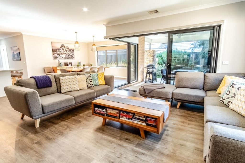 a living room with couches and a coffee table at Amaroo in Bright