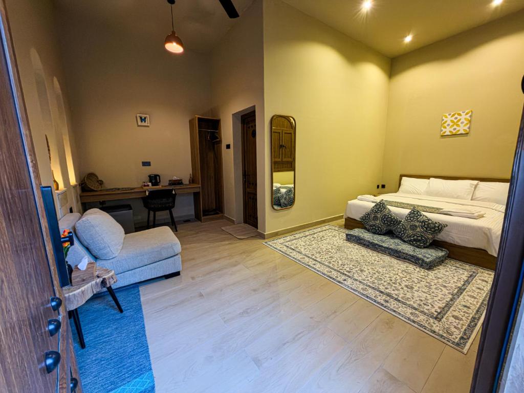 a living room with a bed and a couch at Room 7 in Nizwa