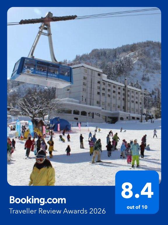 a group of people in the snow under a ski lift at Yuzawa Toei Hotel in Yuzawa