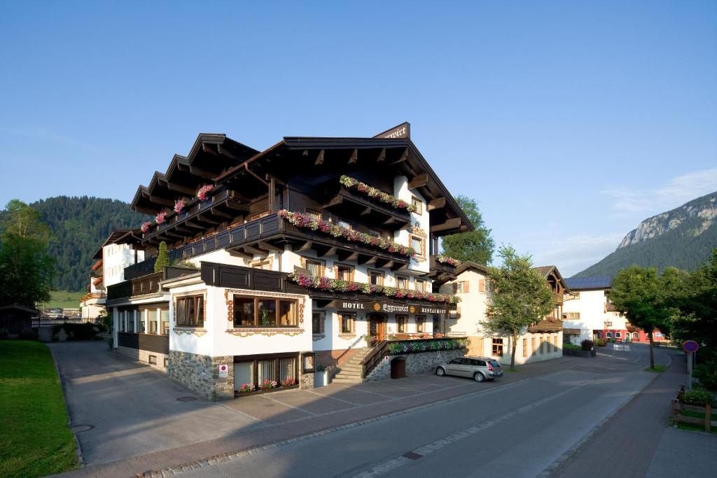 a building on a street with a car parked in front at Hotel Eggerwirt in Söll