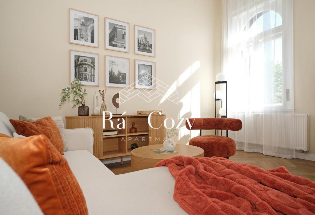 a living room with a couch and a table at Rá-Cozy in Pécs