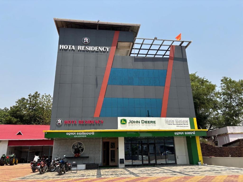 a building with motorcycles parked in front of it at Hota Residency in Sonepur