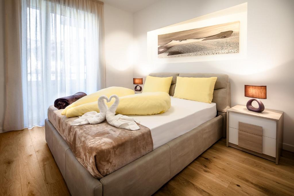a bedroom with a bed with two towels on it at Fior Apartments in Merano