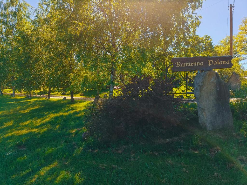 a sign for a park with trees and grass at Kamienna Polana in Szczytna