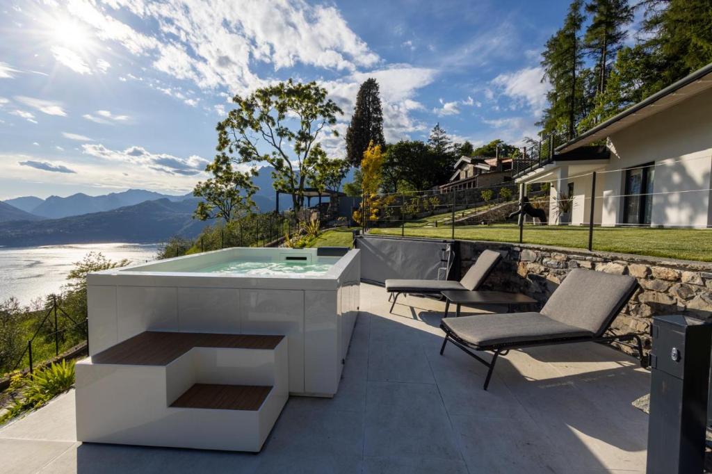a hot tub on the patio of a house at Retrait Lake Como Private Design Retreat with Lake View in Perledo