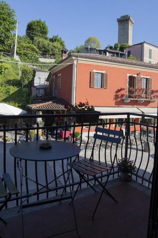 a patio with two tables and chairs and a building at Murazzanino in Murazzano