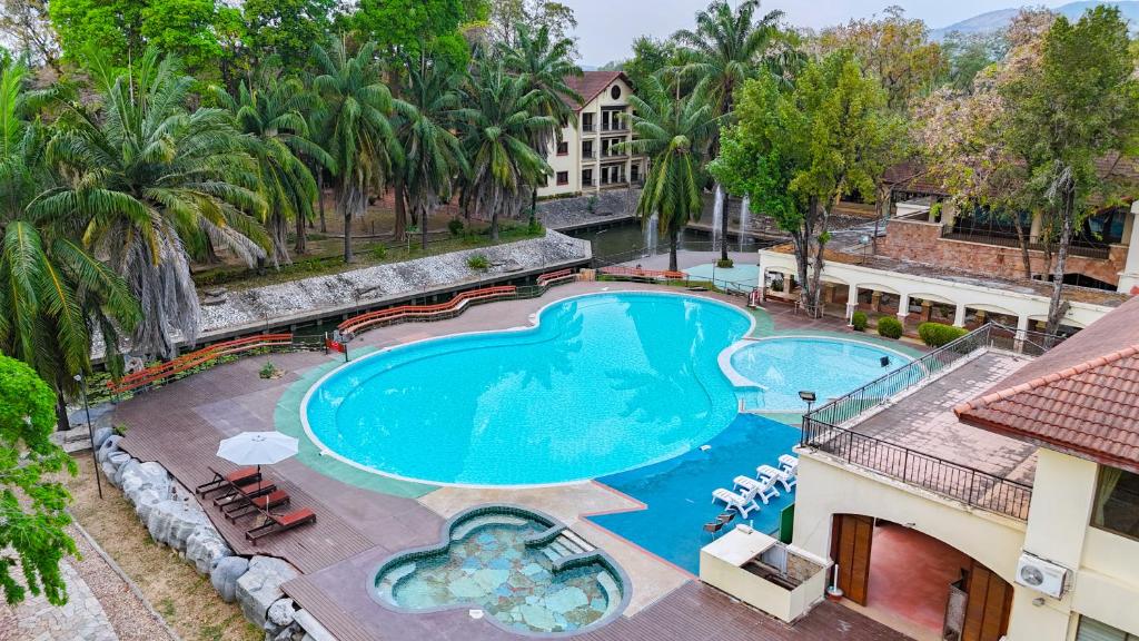 an overhead view of the pool at a resort with palm trees at Pung-Waan Resort & Spa in Kanchanaburi City