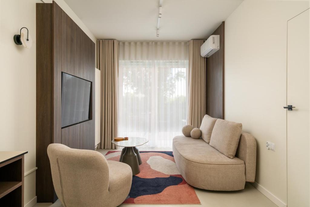 a living room with a couch and a chair at apartamenty-wroc Central Park in Wrocław