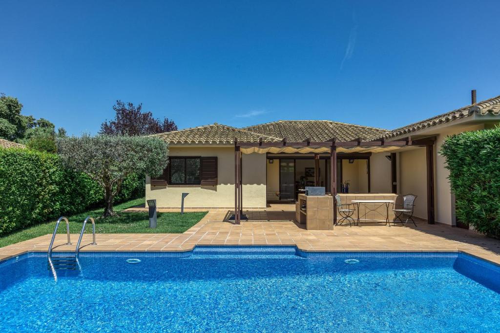 a swimming pool in front of a house at Villa Greta in Navata