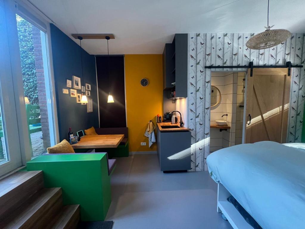 a bedroom with a bed and a desk and a table at Sint Lambertusstraat in Eindhoven