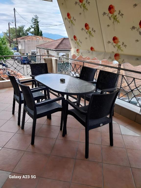 a table and chairs on a balcony with a view at Menidi Apartment 201 in Menídion