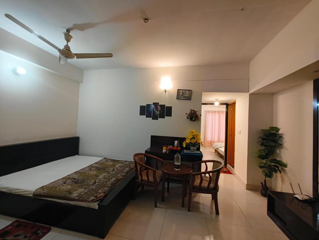 a bedroom with a bed and a table with chairs at World Beach Resort in Cox's Bazar