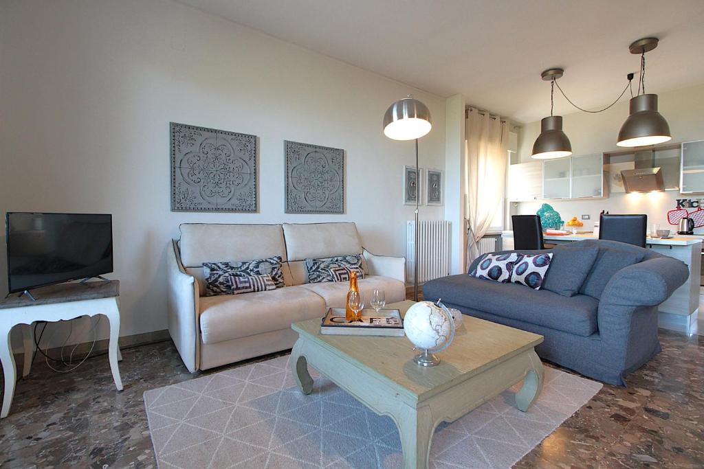 a living room with a couch and a table at Catullo 18 Apartment, Garda Lake, Jacuzzi, Fitness, Ac in Desenzano del Garda