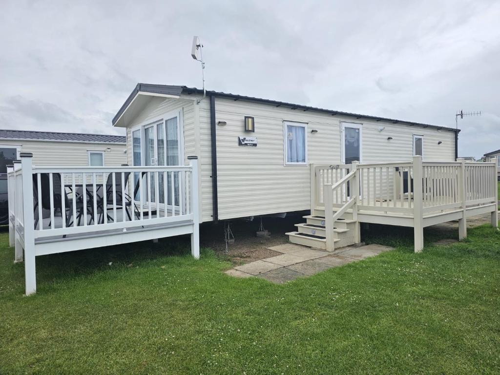 a white house with a porch and two decks at Iris - D6 in Eyemouth