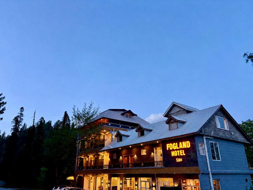 a building with a sign that reads per end world at Fogland Hotel Nathia Gali in Nathia Gali