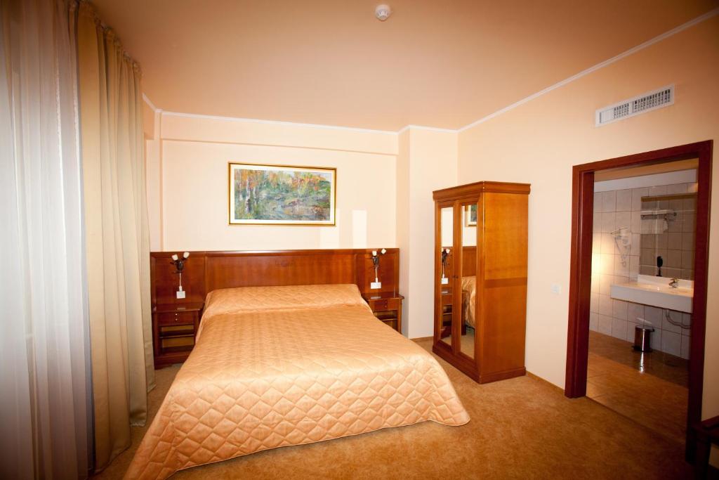 Postel nebo postele na pokoji v ubytování Hotel Maxim