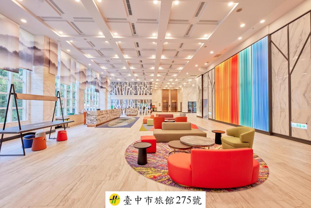a lobby with colorful furniture and a piano at Uni-Resort Ku-Kuan in Heping