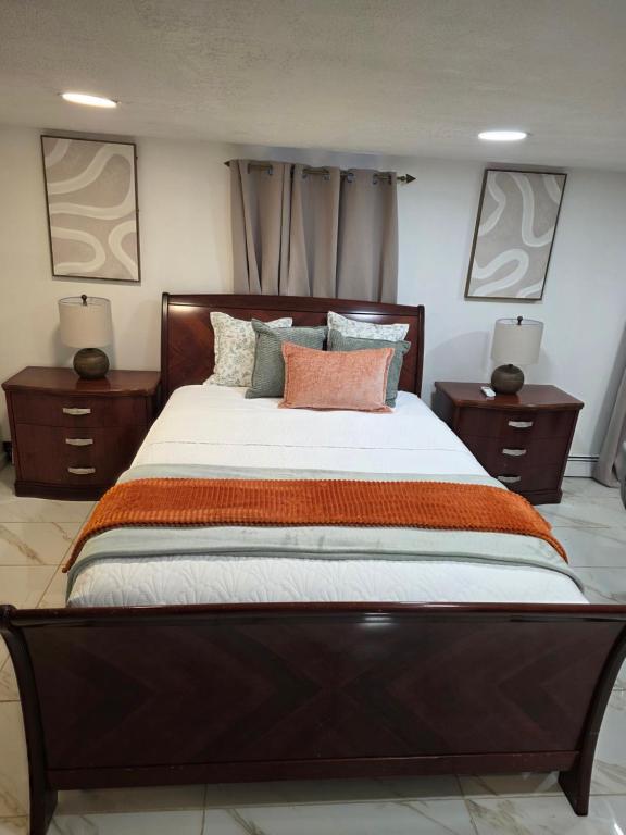 a bedroom with a large bed with two night stands at Tropical Oasis in Rosedale