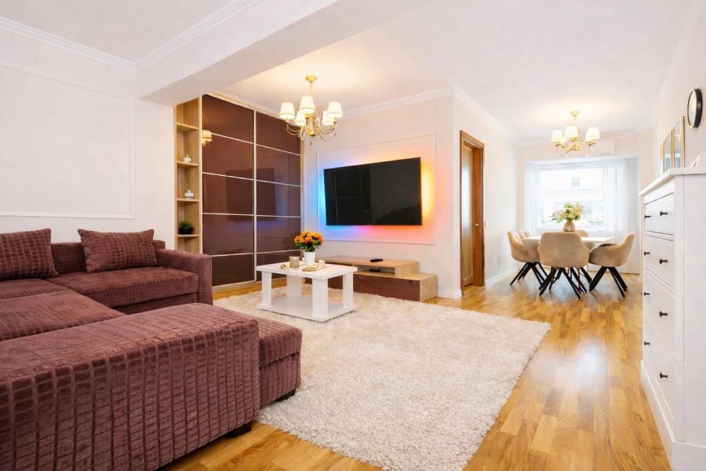a living room with a couch and a table at Mid Velvet Apartment, Free Parking, Self Check-in in Oradea