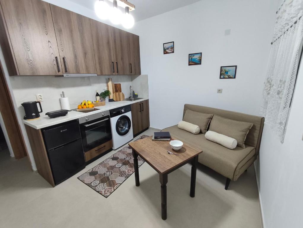 a small kitchen with a couch and a table at Prikas Apartments A in Kefalos