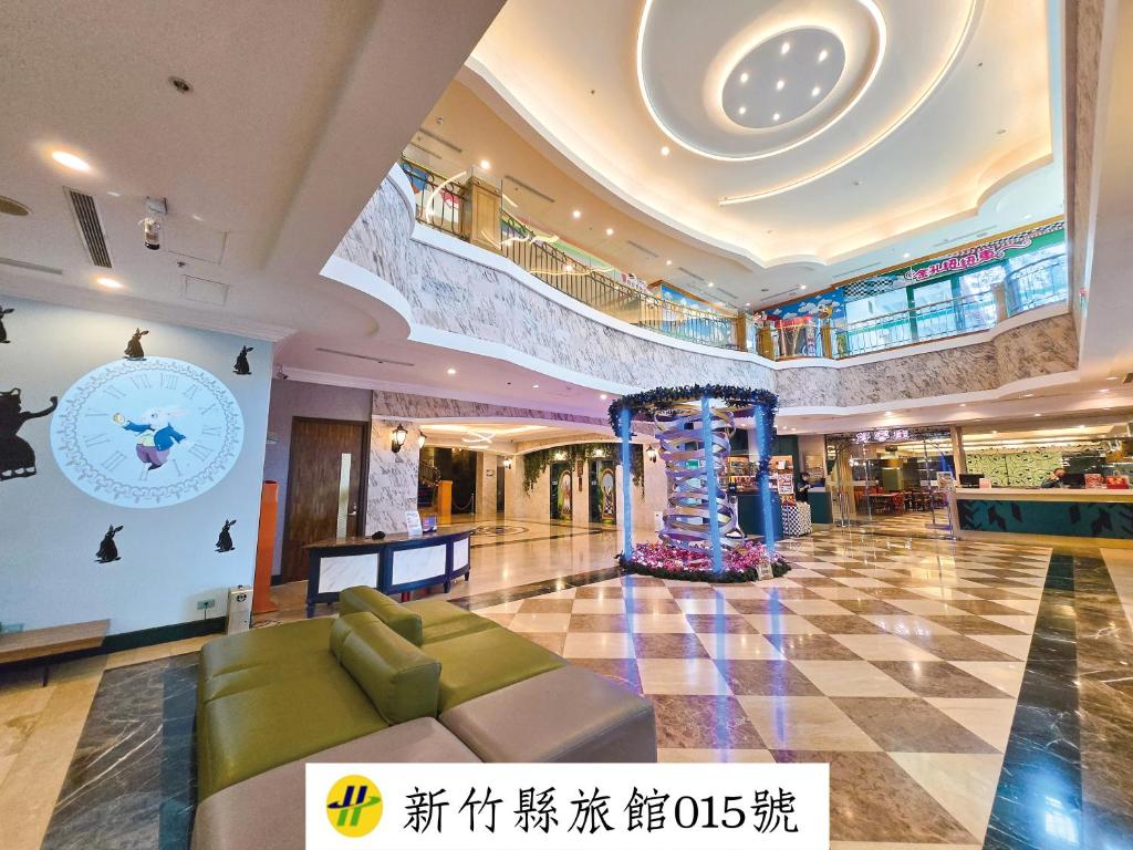 a large building with a lobby with a clock on the wall at Uni-Resort Mawutu in Guanxi
