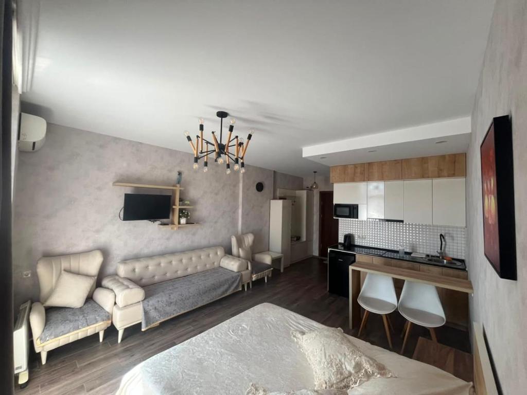 a living room with a couch and a kitchen at Gio apartment in Angisa