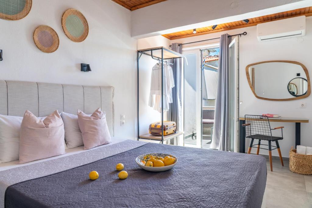 a bedroom with a bed with a bowl of fruit on a table at Australia in Skiathos