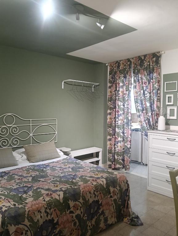 a bedroom with a bed and a dresser and a window at Liberty 21 in Andria