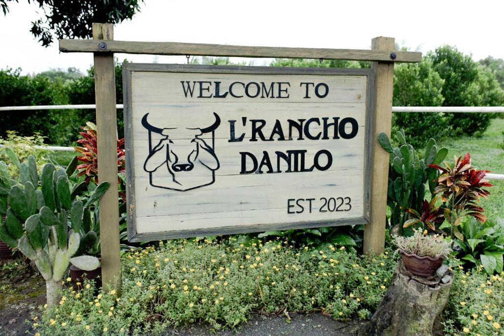 a sign for a garden with a welcome to lancoco danu at The Stables by L' Rancho Danilo in Banaba