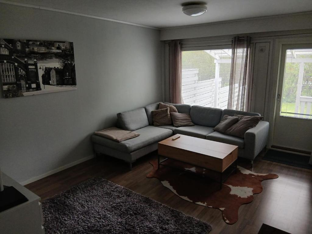 a living room with a couch and a coffee table at Apartment in Raahe