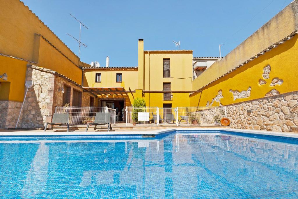 a large swimming pool in front of a building at Casa Rural Ca La Siona in Avinyonet